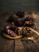 Still life with a sea urchin and black pudding