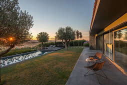 Terrace with view of pool at sunset