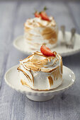 Iced meringue tarts with strawberry filling