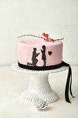 Pink wedding cake with black paper cut out decorations
