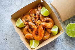 Fried shrimps with lime slices in the fast food delivery box