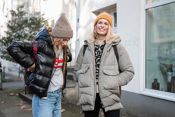 Two women in autumn clothes taking a walk