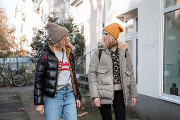 Two women in autumn clothes taking a walk