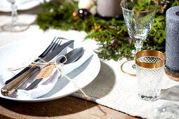 Place setting with white napkin on Christmas table