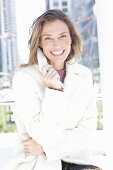 Joyful woman in white coat