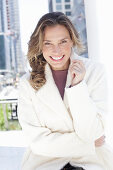 Joyful woman in white coat