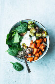 Buddha Bowl with sweet potatoes, Brussels sprouts, spinach and quinoa