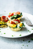 Egg muffins from the oven with spinach and tomatoes