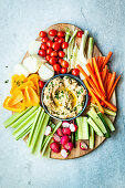 Vegetable platter with vegetable sticks with hummus