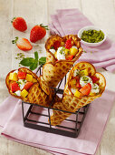 Waffle cones filled with fruit, mascarpone and pistachio nuts