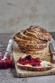 Slice of bread with butter and rhubarb and wild berry jam