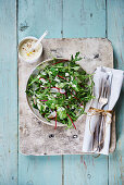 Rocket field salad with sorrel and radishes with Dijon mustard dressing