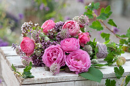 Lying bouquet of roses, starthistle and oregano flowers