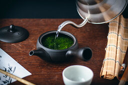 Japanese green tea made with loose leaves being poured
