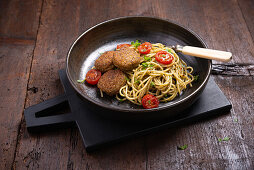 Spaghetti with falafel, pesto and grilled cocktail tomatoes