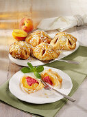 Peaches wrapped in puff pastry with raspberry jam and marzipan