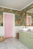 Pink coffered door in classic bathroom with wallpaper