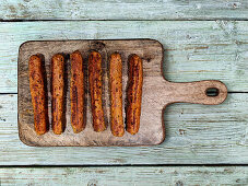 Vegan sausages on wooden board