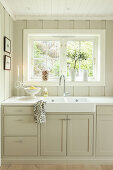 Sink below window of kitchen in Long Island style