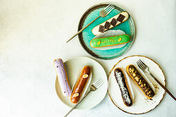 Variety of tasty french dessert eclair on the plates