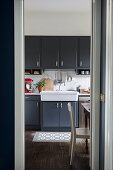 Fitted kitchen in tones of grey with butlers' sink