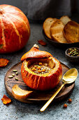Pumpkin soup served in a hollowed out pumpkin