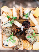 A cheese platter with bread and fig chutney