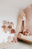Girls' room with wooden bed and canopy in nude shades
