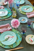 Gedeckter Tisch mit Blumen und Vogelfigur