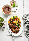 Homemade minced meat schnitzel with puree, fried onions and side salad