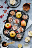 Apple rose muffins in a muffin tin