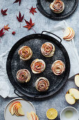 Apple rose muffins on a black platter
