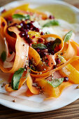 Carrot salad with red grapes, pomegranate seeds and fennel seeds