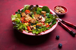 Salad with bell pepper, corn, walnuts, blueberries