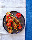 Minced meat skewers with fried zucchini and tomatoes