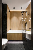 Small bathroom with wood paneling and black marble