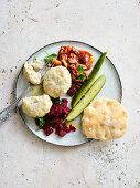 Filleted fish with beetroot, warm olive sauce and pickled cucumber