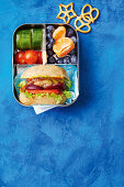 Mini-Cheeseburger, Gemüse und Obst in Lunchbox