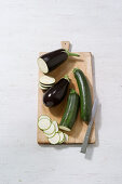 eggplant and zucchini on wooden chopping board