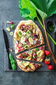 Pizza with rhubarb, radish, brie, strawberries and poppy seeds