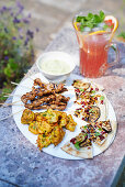 Harissa beef skewers, Aubergine and pomegranate flatbreads, Grapefruit mojito