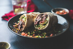 Beef burrito with avocado and tomatoes