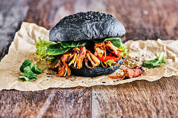 Vegan pulled pork burger with black buns
