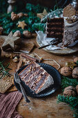 Piece of chocolate walnut cake with rum and chocolate custard for Christmas