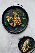 Stuffed sweet potatoes with cream cheese, spinach and microgreens