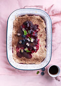 Vegan layered dessert of almond sponge cake, semolina cream and blueberries