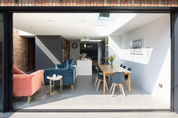 View into open-plan interior with dining area and lounge