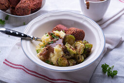 Vegan potato-celery mash with Brussels sprouts and beetroot falafel