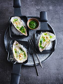 Oysters on a bed of salt in raclette pans