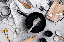 Frying pan, plate, small bowls, cutlery, and linen napkin